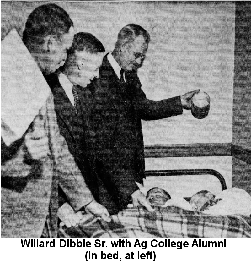 Black and white newspaper photo of Willard Dibble, Sr. lying in a narrow metal-framed bed under a plaid blanket with an Agricultural College alumnus as three professors look on, one holding a can of water about to be poured on the 'late sleepers'.
